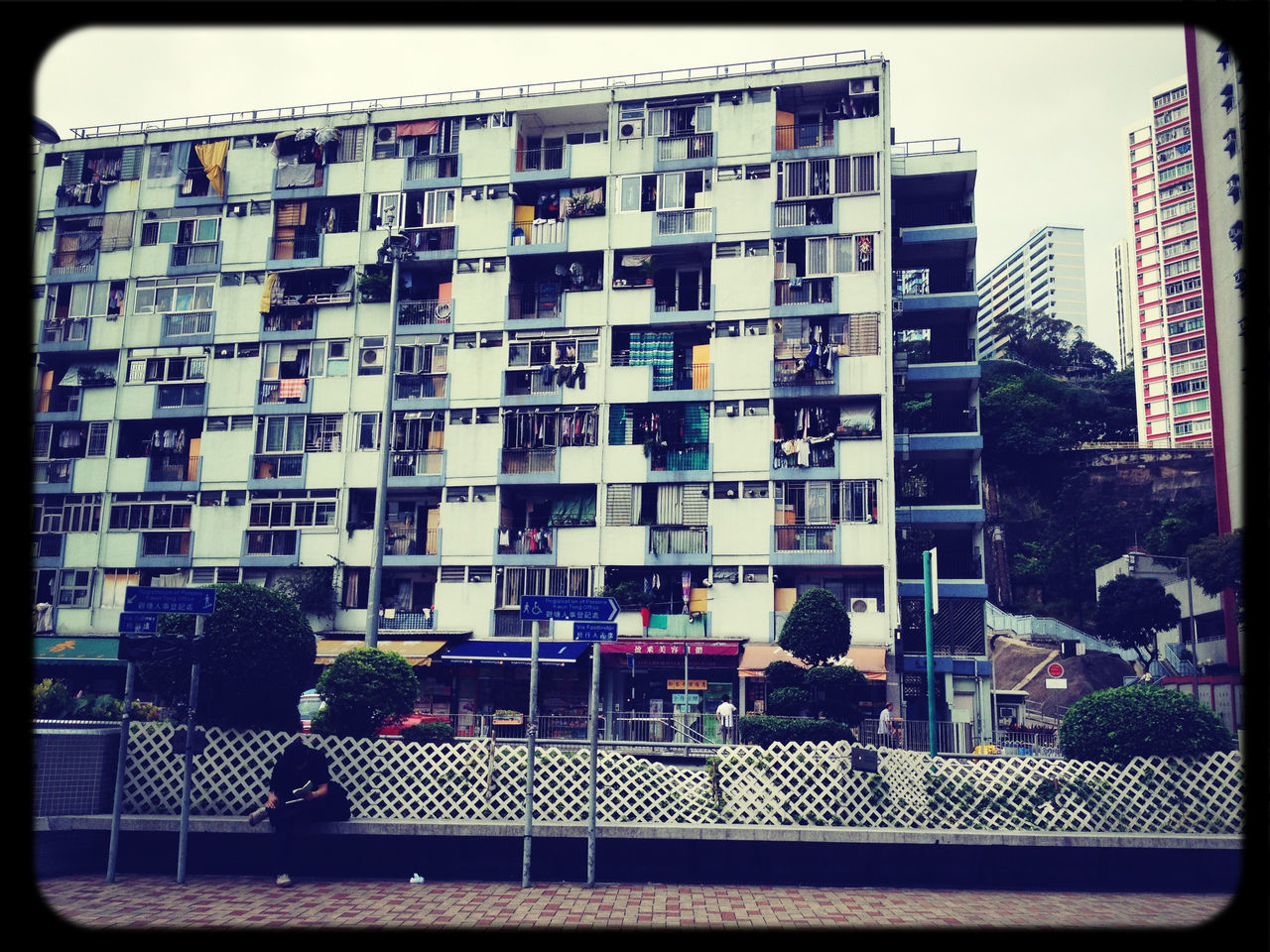 building exterior, architecture, built structure, transfer print, city, auto post production filter, railing, residential building, building, window, balcony, residential structure, city life, day, outdoors, sunlight, sky, low angle view, house, glass - material