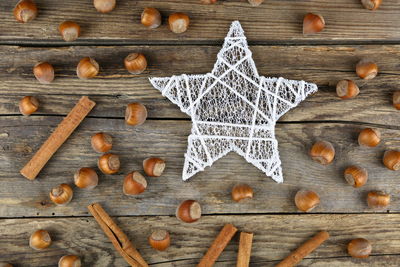 Directly above shot of christmas decoration with hazelnuts on table