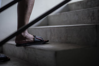 Low section of person standing on staircase