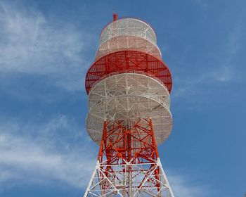 Low angle view of communications tower against sky