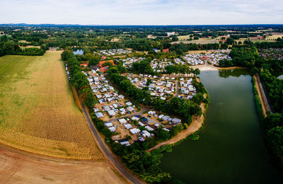 High angle view of river amidst cityscape against sky