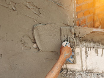 Close-up of human hand on wall