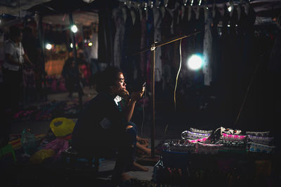 Woman using smart phone at market
