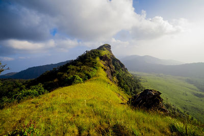 Scenic view of green landscape against sky