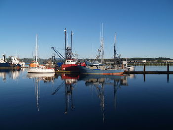 Boats moored at harbor