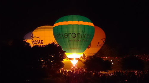 Illuminated hot air balloon against sky at night