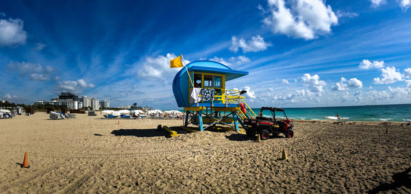 Lifeguard hut on beach against sky