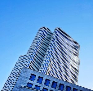 Low angle view of modern building against clear blue sky