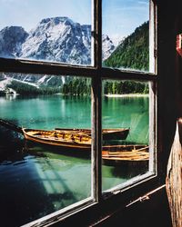 Scenic view of lake and mountains seen through window