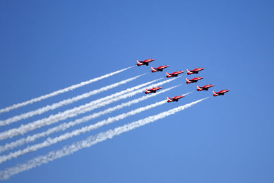 Low angle view of airshow against clear sky