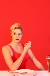 Portrait of young woman sitting at table