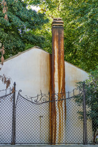 Close-up of metal fence against trees