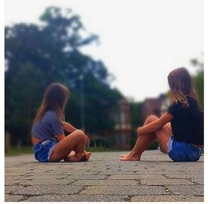 Rear view of woman sitting on bench