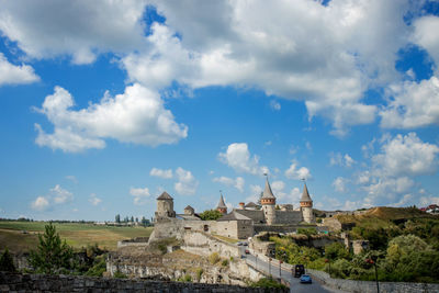 Buildings against cloudy sky