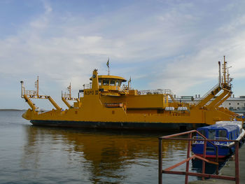 Commercial dock by sea against sky