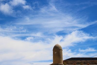 Low angle view of factory against blue sky