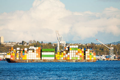 Commercial dock by sea against sky