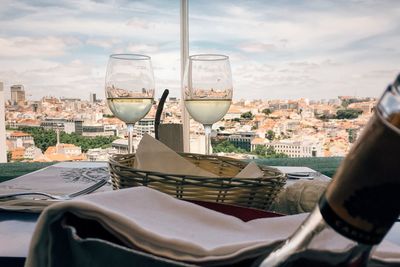 White wine in glass against city