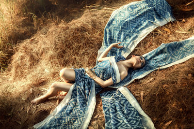 High angle view of man lying on grass