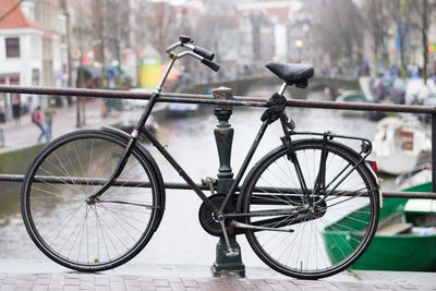 Bicycle parked against building in city