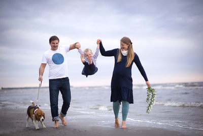 Full length of happy family at beach