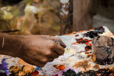 Close-up of person holding paint