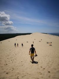 Man at beach against sky