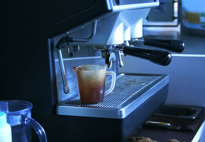 Coffee machine pouring cappuccino into a cup