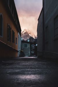 Empty alley amidst buildings in city