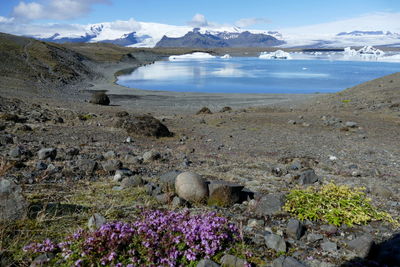 Scenic view of sea and mountains against sky