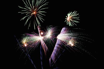 Low angle view of firework display at night