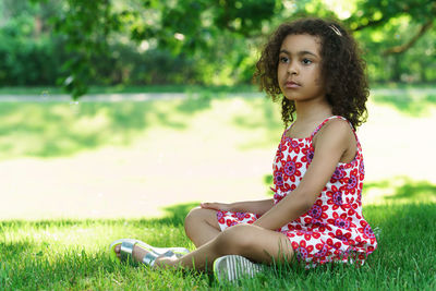 Young woman sitting on field