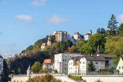 View at fortress veste oberhaus in passau during a ship excursion in autumn with colorfull trees