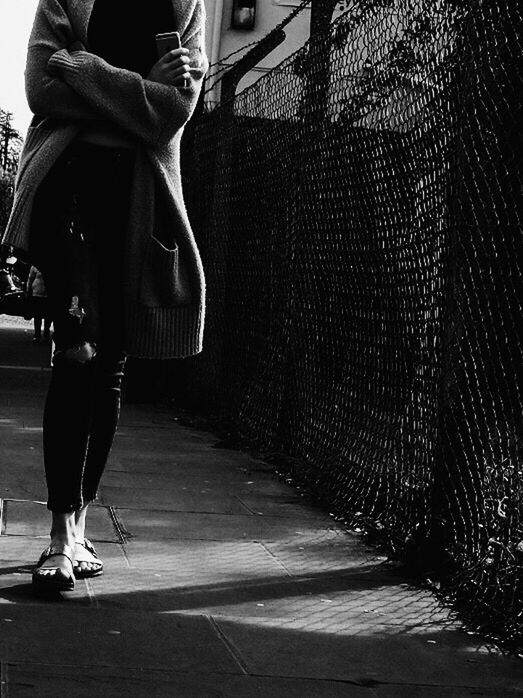 LOW SECTION VIEW OF MAN WALKING ON STREET