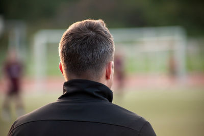 Rear view of man standing outdoors