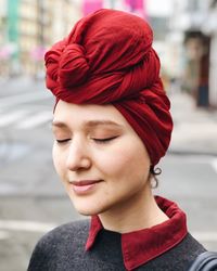 Close-up of woman wearing red headscarf while standing on road