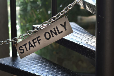Close-up of text on metal railing