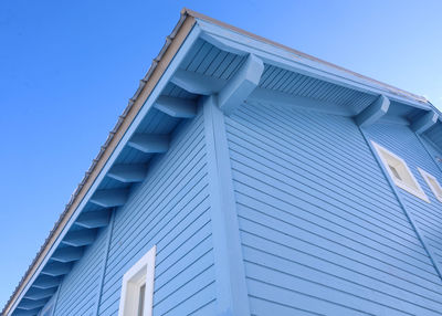 Low angle view of building against clear blue sky