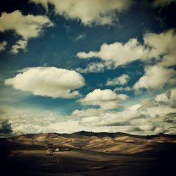 Scenic view of mountains against cloudy sky