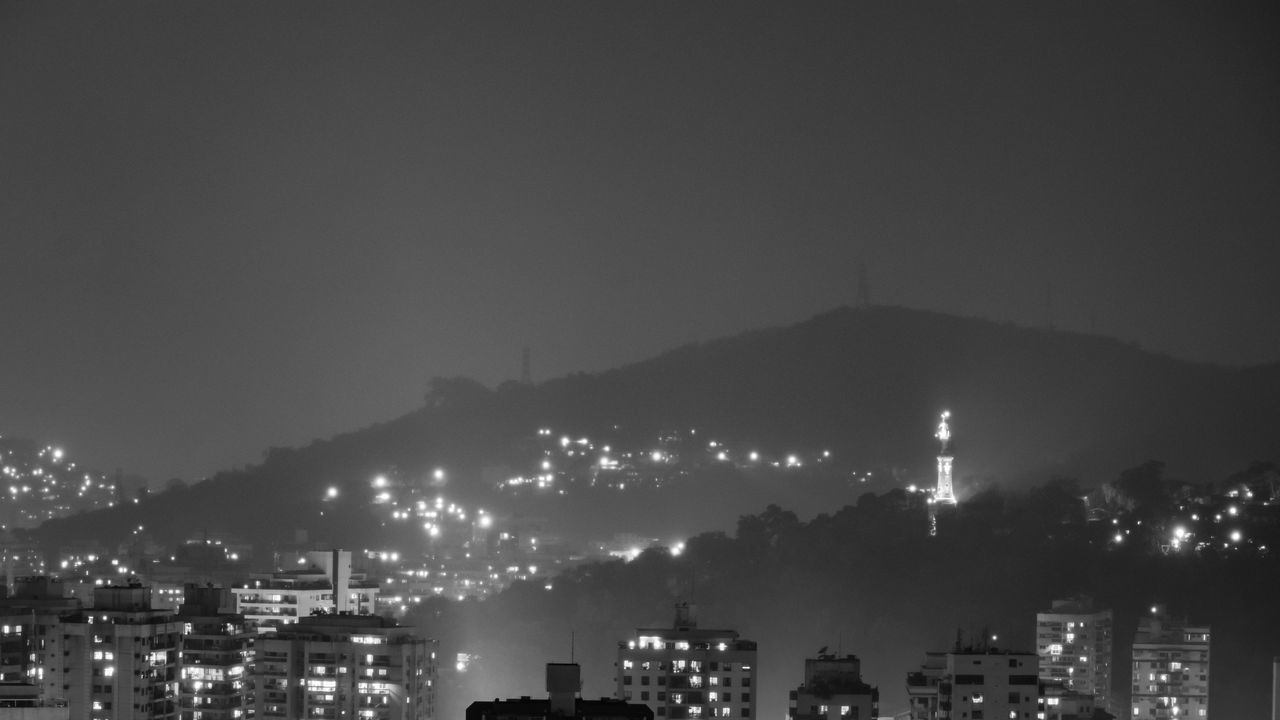 ILLUMINATED CITY AGAINST SKY AT NIGHT