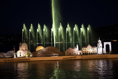 Panoramic view of illuminated buildings against sky at night