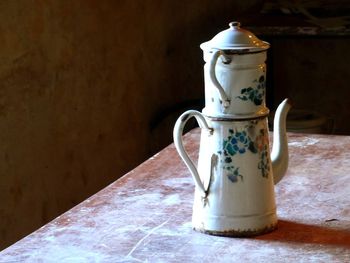 Close-up of drink on table against wall