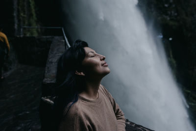 Portrait of young woman looking up