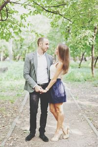 Young couple holding hands in park