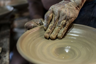 Midsection of person preparing food in mud