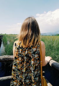 Rear view of woman looking at field