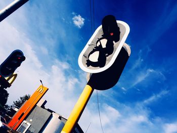 Low angle view of road sign against sky