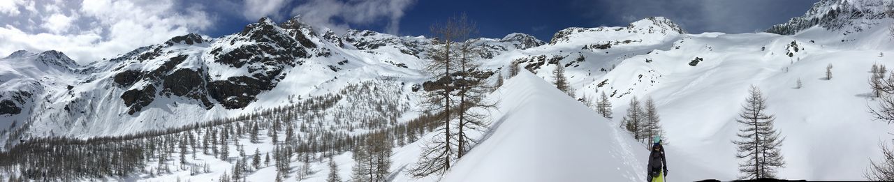 Panoramic view of snow covered mountain against sky