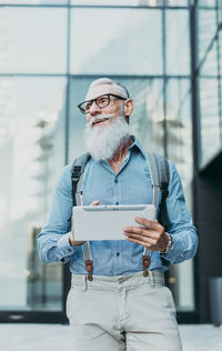 Man using smart phone outdoors