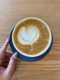 Midsection of coffee cup on table